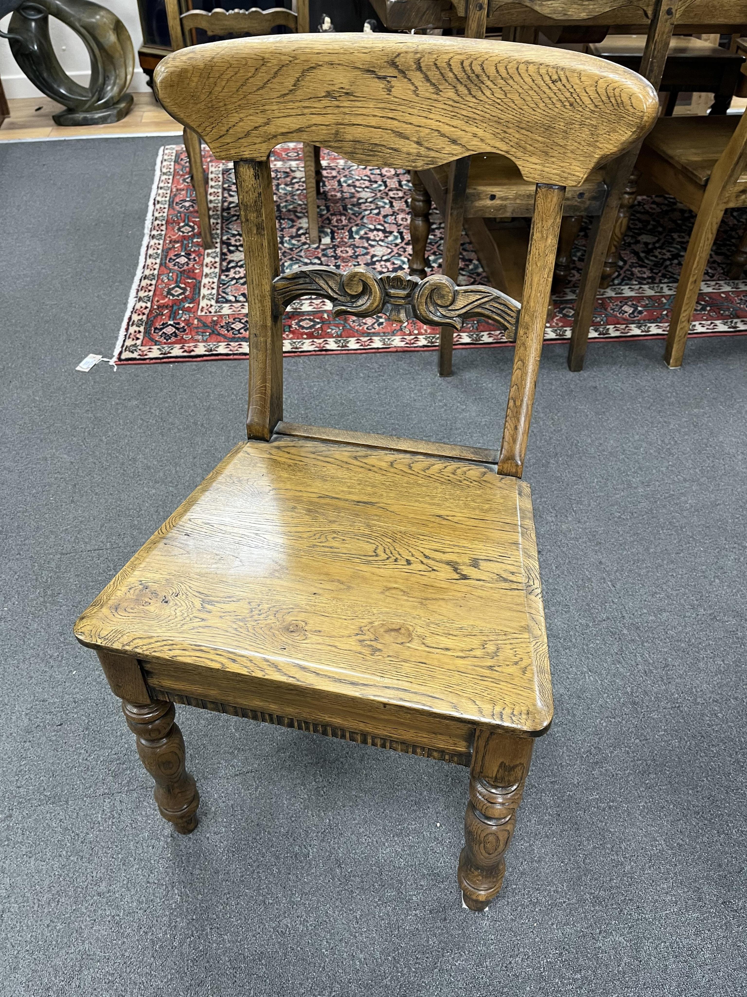 A set of twelve reproduction Victorian style oak wood seat dining chairs, width 47cm, depth 39cm, height 88cm. Condition - good